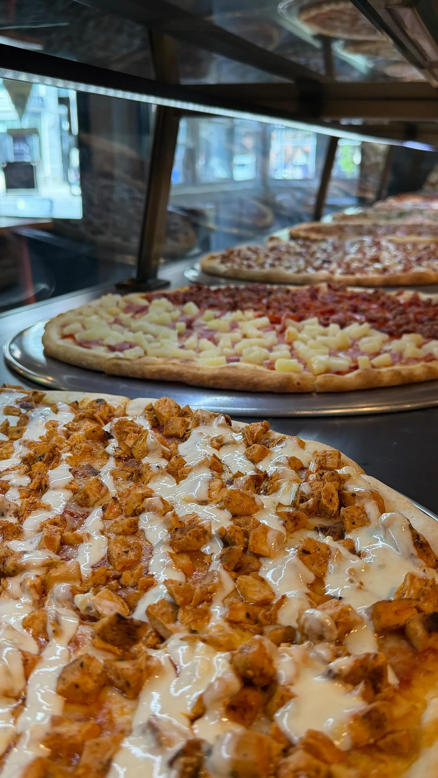 A close look at the pizzas at Rosa’s Harlem counter